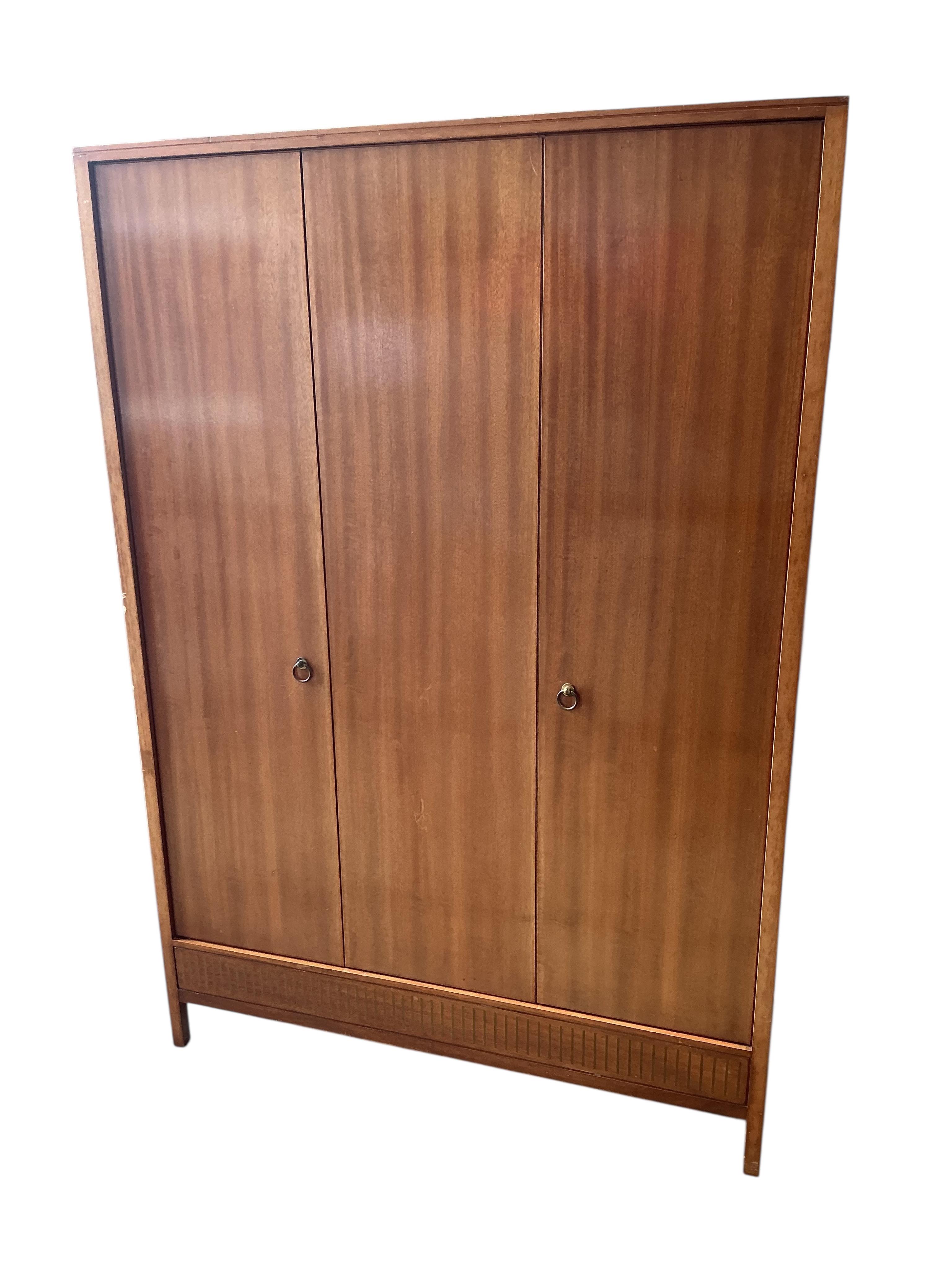 A Loughborough For Heals brass inlaid teak four piece bedroom suite comprising: triple wardrobe, width 120cm, depth 54cm, height 176cm, two chests of drawers and a toilet mirror